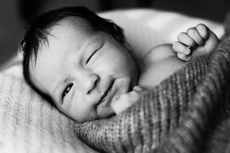 newborn baby winking at you